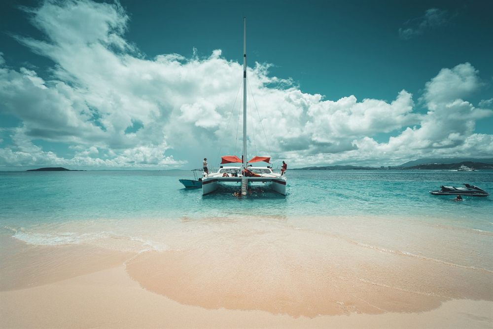 Catamaran anchored off a white-sand Caribbean beach in Puerto Rico