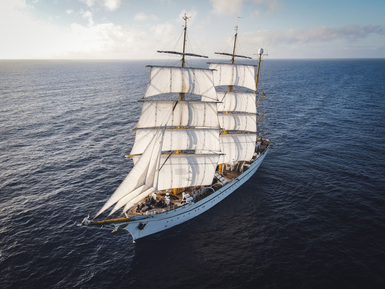Tall ship under full square sails on the open sea, seen from above, the spirit of tall ship group sailing