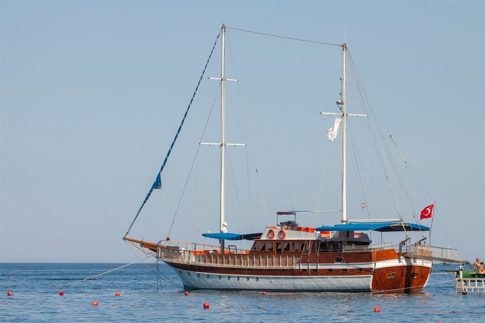 Wooden Turkish gulet flying the Turkish flag, anchored in calm Mediterranean water