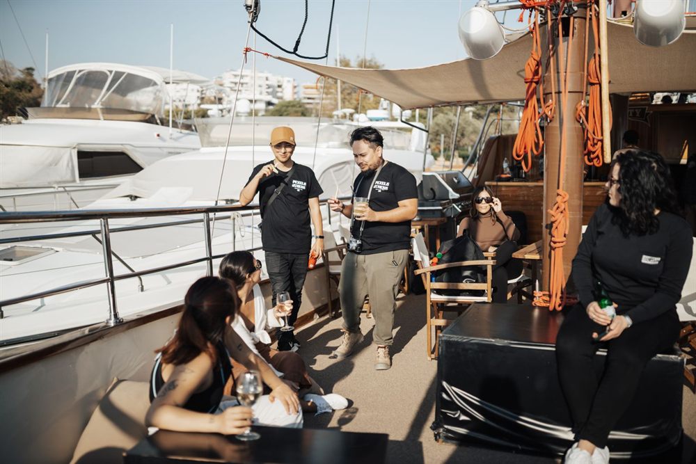 Friends chatting on a yacht deck at a marina before setting sail